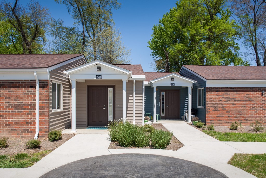a building with two doors and a sidewalk in front of it
