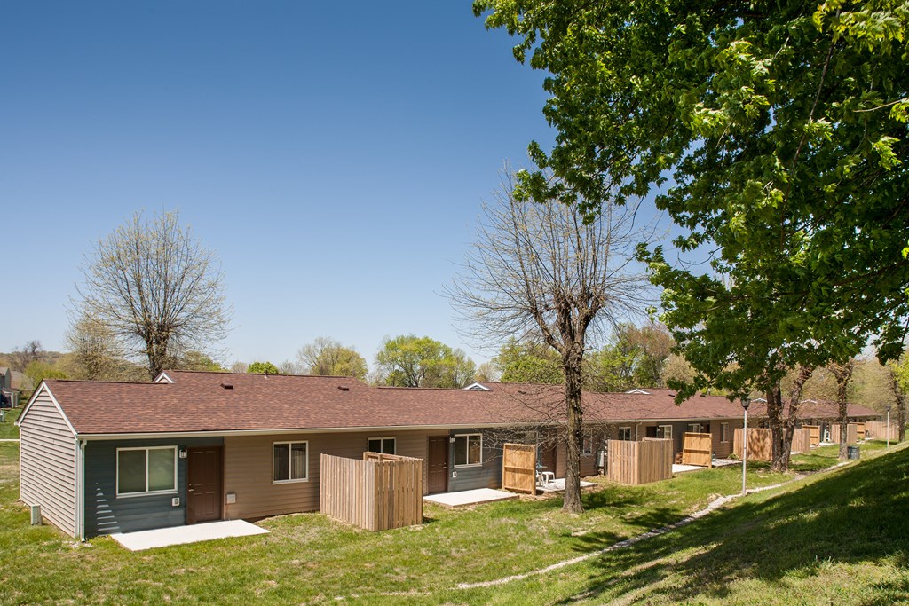 a view of a house with a yard and trees