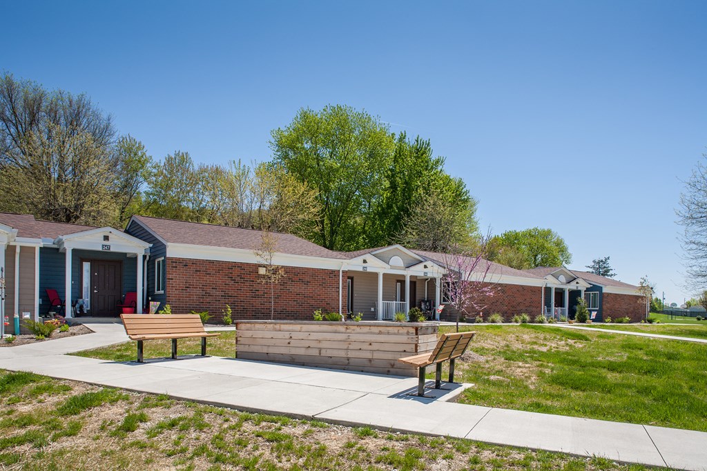 a brick building with two benches in front of it