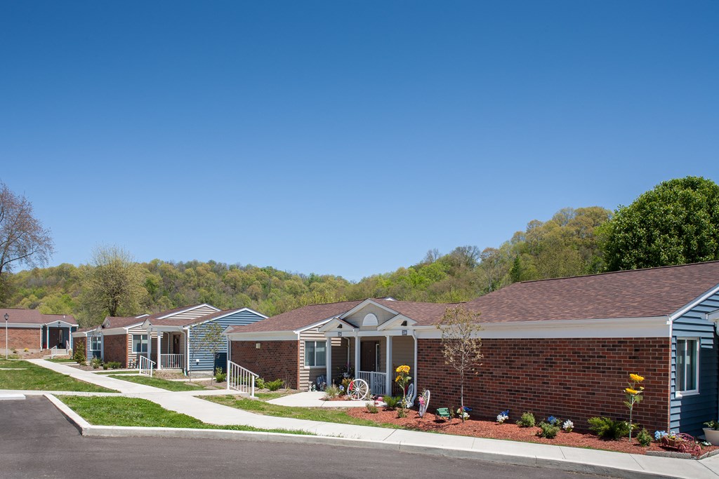 a row of houses on a street with a blue sky