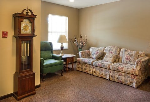 a living room with a couch and a grandfather clock