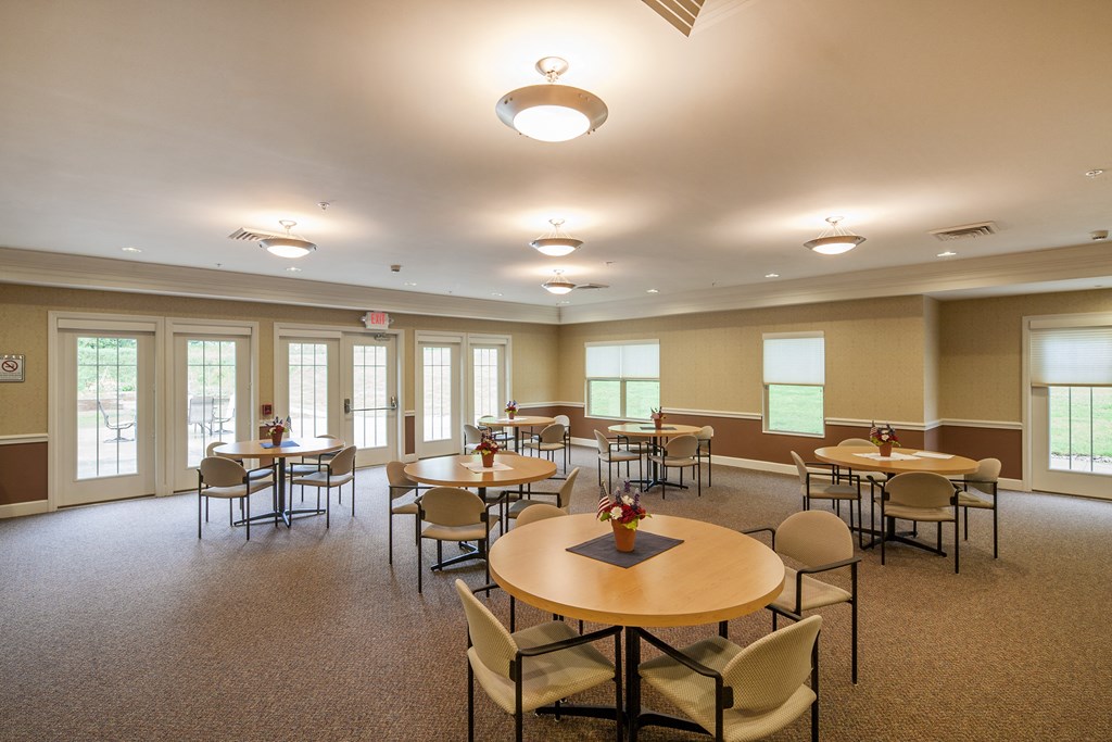 a multipurpose room with tables and chairs