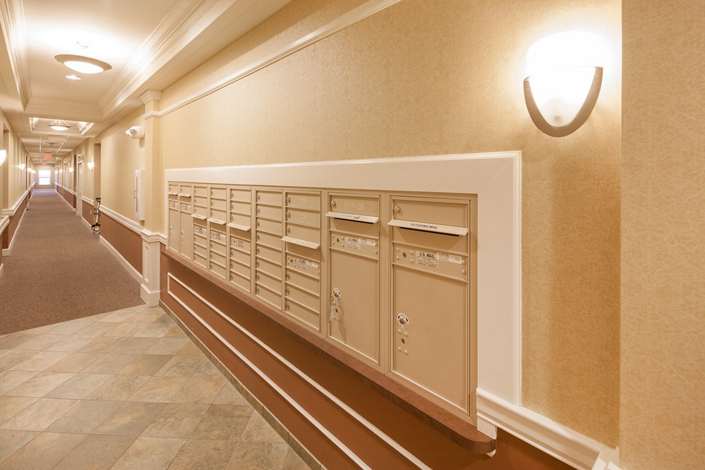 a view of the mailboxes in the hallway of a building