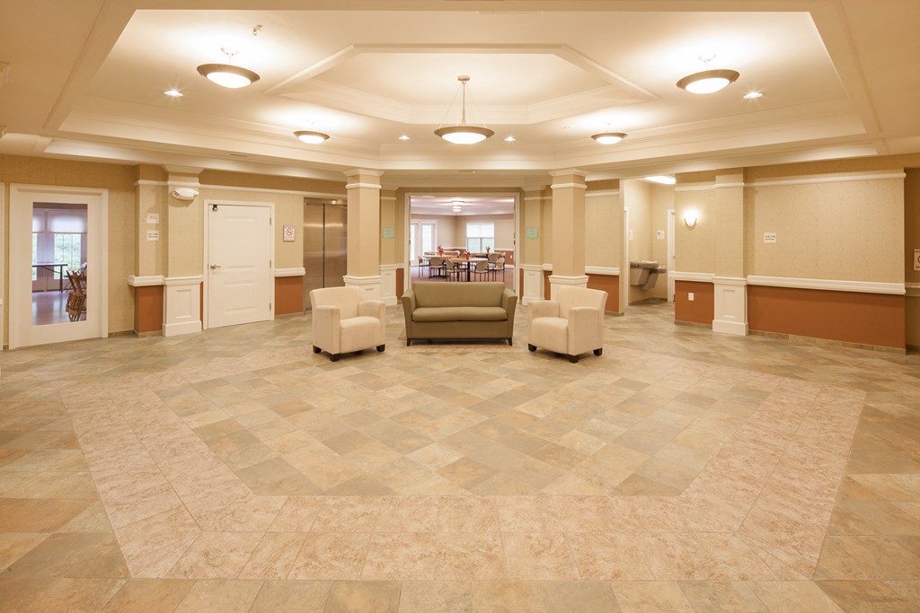 a large room with a seating area and chairs in it