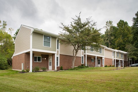 a row of houses with a yard in front of them
