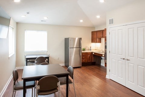 a kitchen and dining room with stainless steel appliances and a table