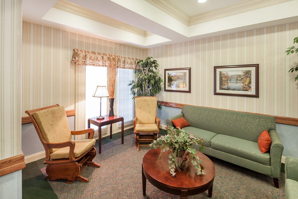 a living room with a couch and chairs and a table