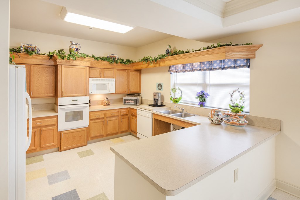 a kitchen with wooden cabinets and appliances and a counter top