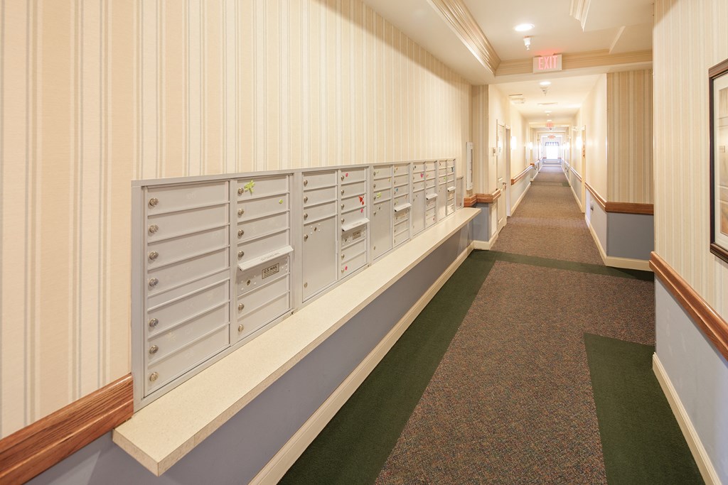 a long hallway with rows of mailboxes in a building
