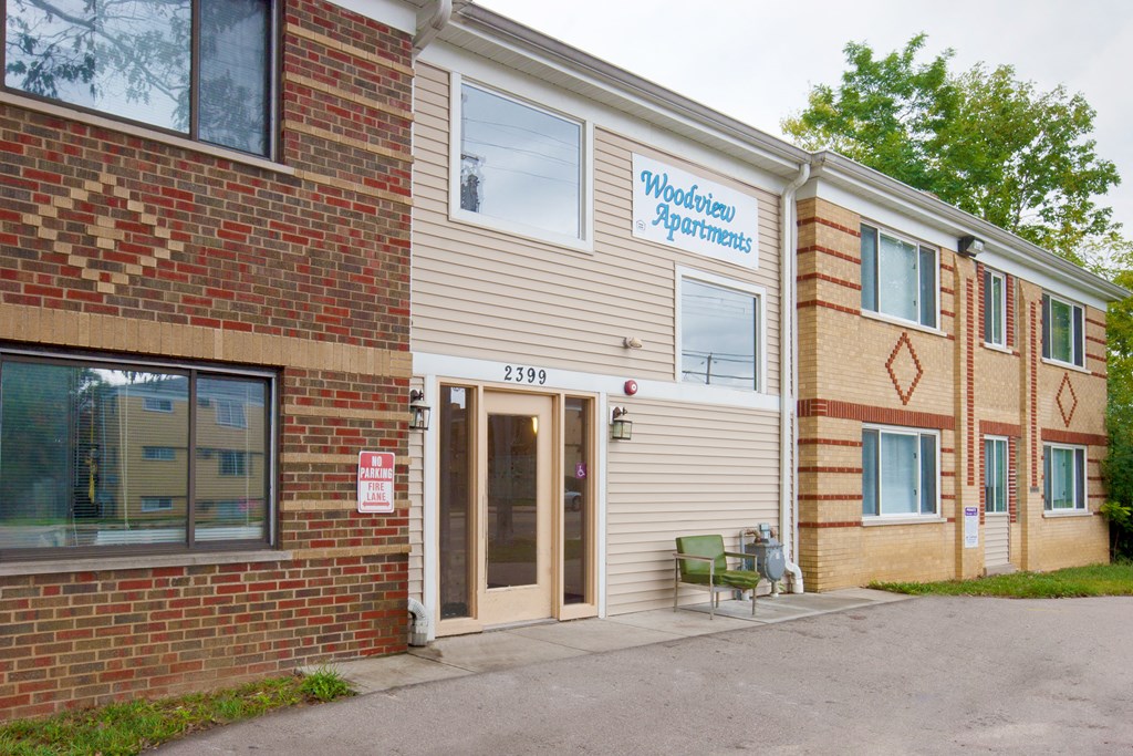 a brick building with a door and a sign on the side of it