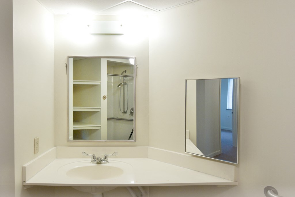 a small bathroom with a sink and a mirror