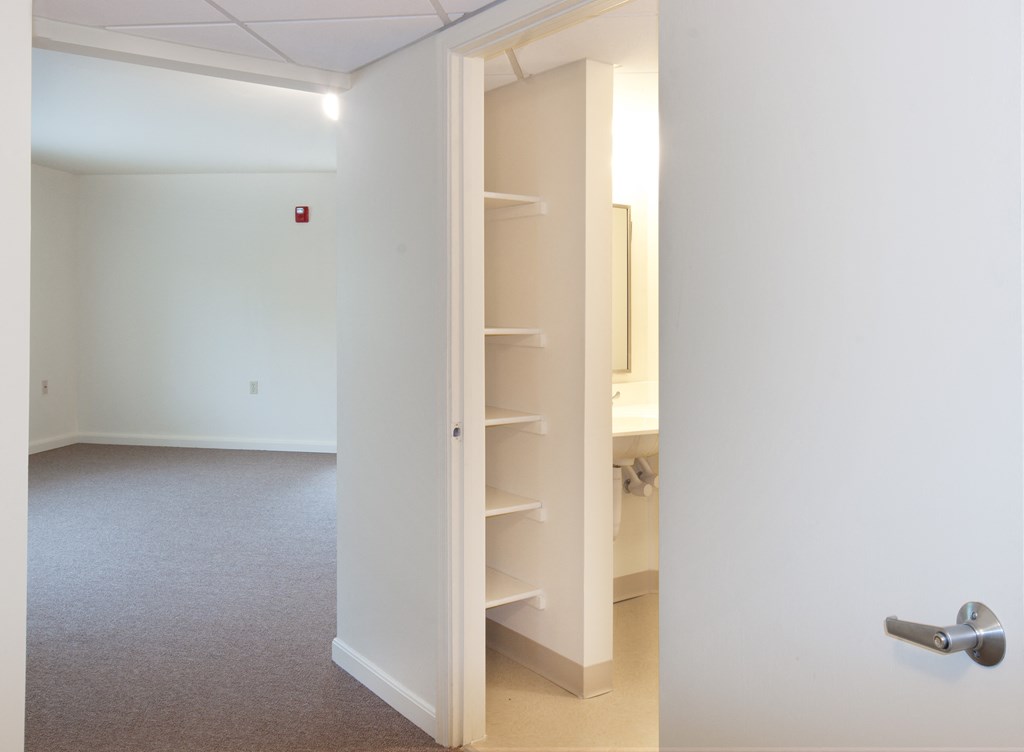 an empty room with a closet and a door