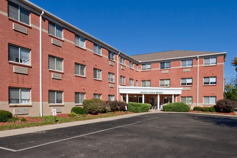 a large brick building with a driveway in front of it