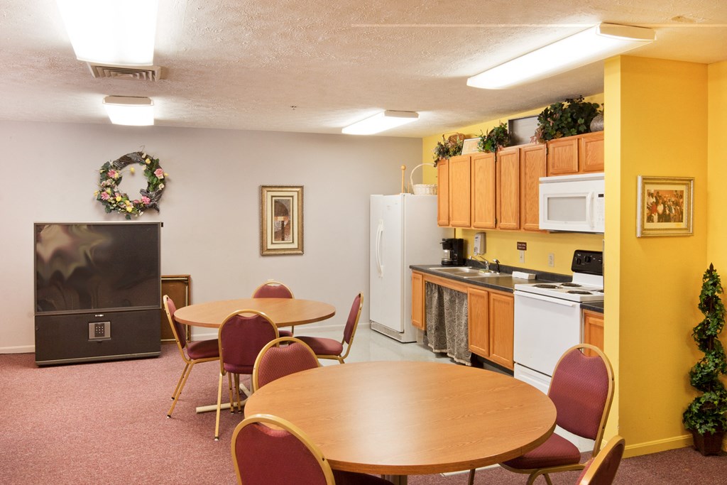 a dining room with a kitchen with a table and chairs