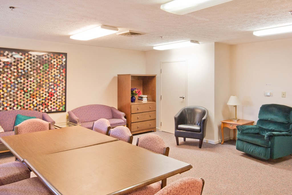 a meeting room with a table and chairs
