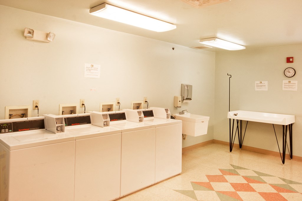 a public restroom with a row of sinks and urinals