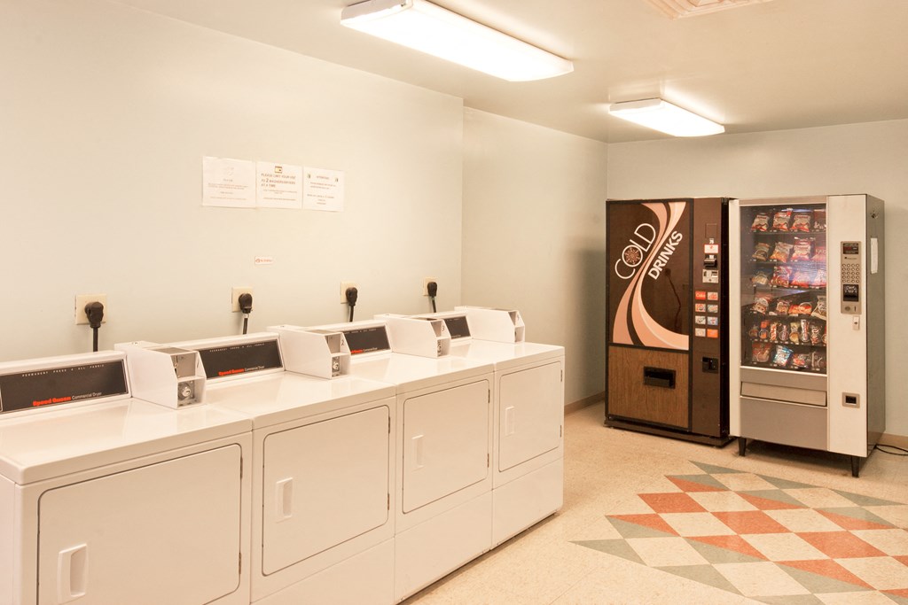 a laundry room with washers and dryers and a vending machine