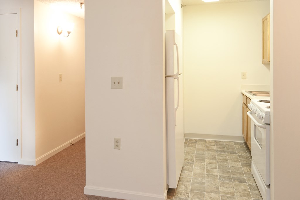 a kitchen with white appliances and a white refrigerator