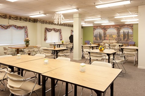 a dining room filled with tables and chairs in a classroom