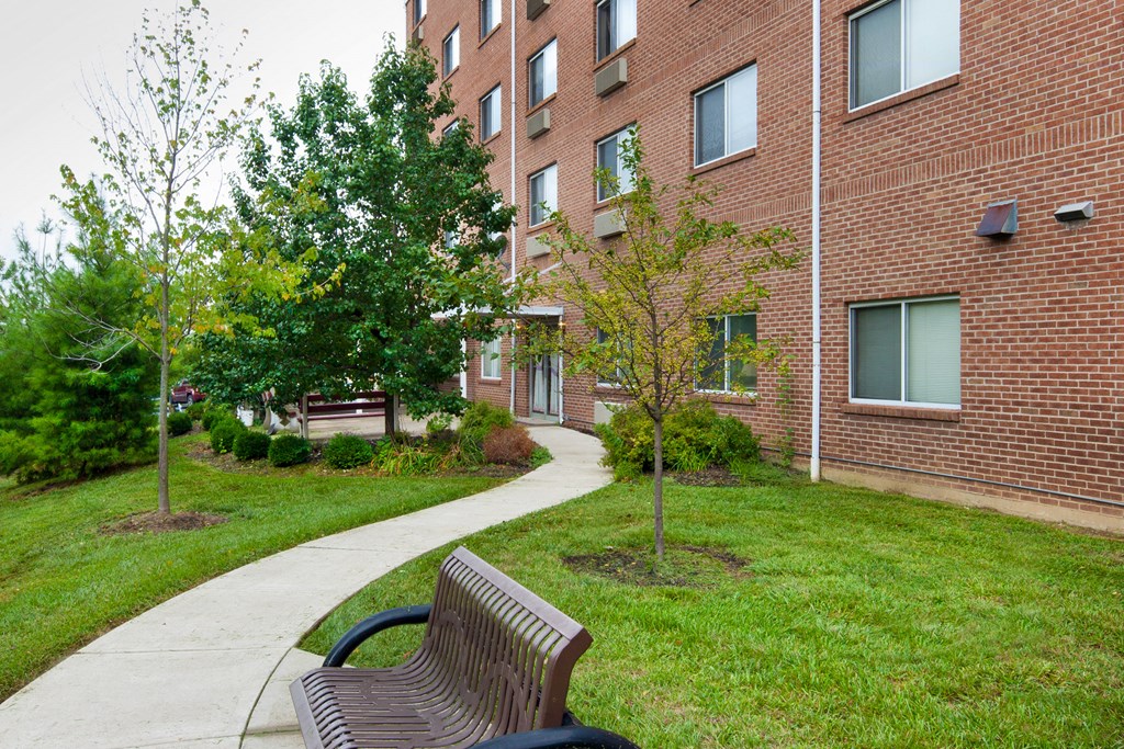 a park bench in front of a brick building