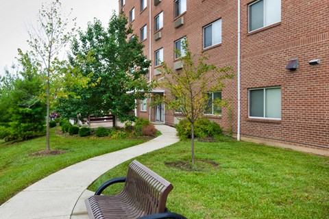 a park bench in front of a brick building
