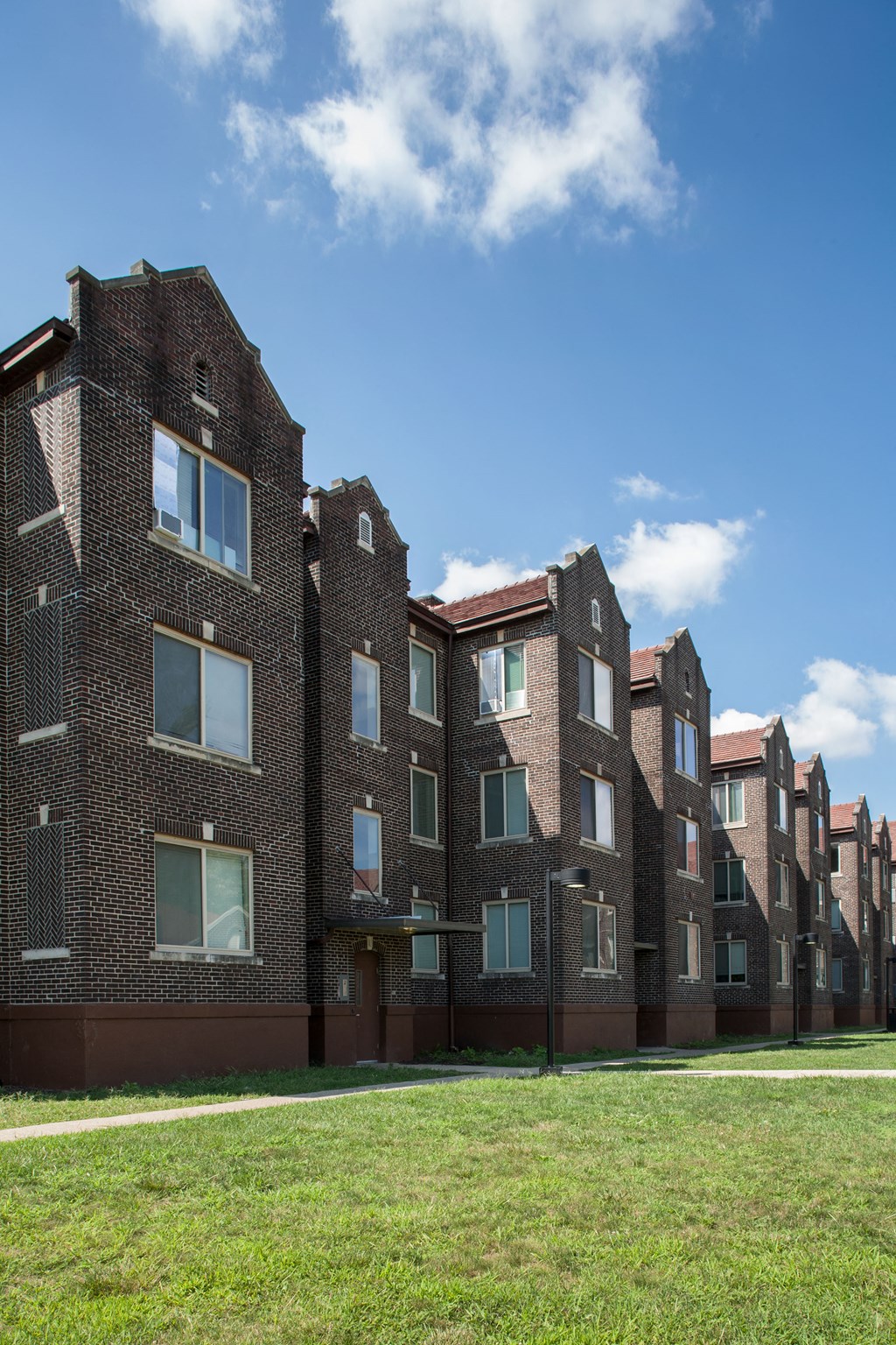 a row of brick apartment buildings on a sunny day