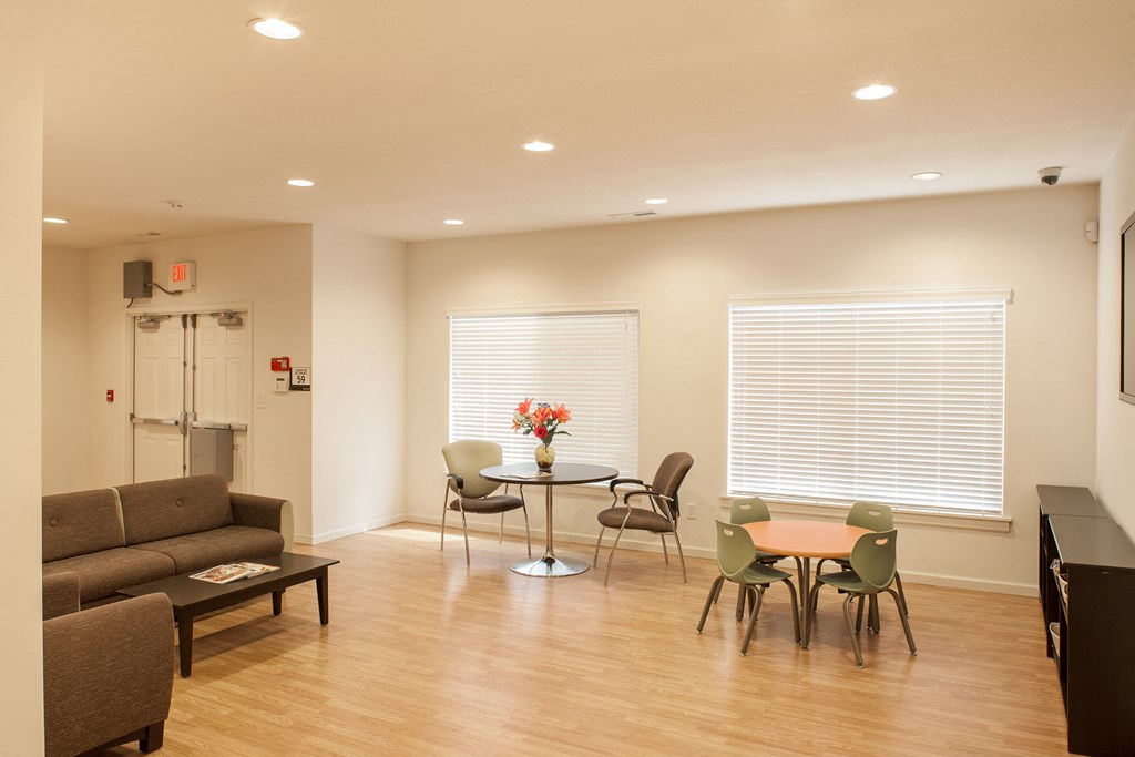 a living room with a table and chairs and a couch