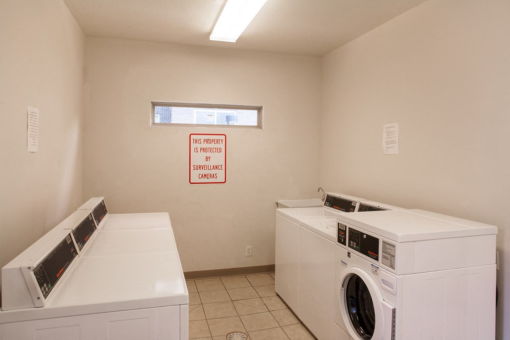 a laundry room with two washes and two dryers