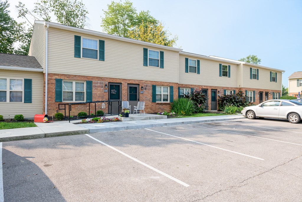 a parking lot in front of an apartment building