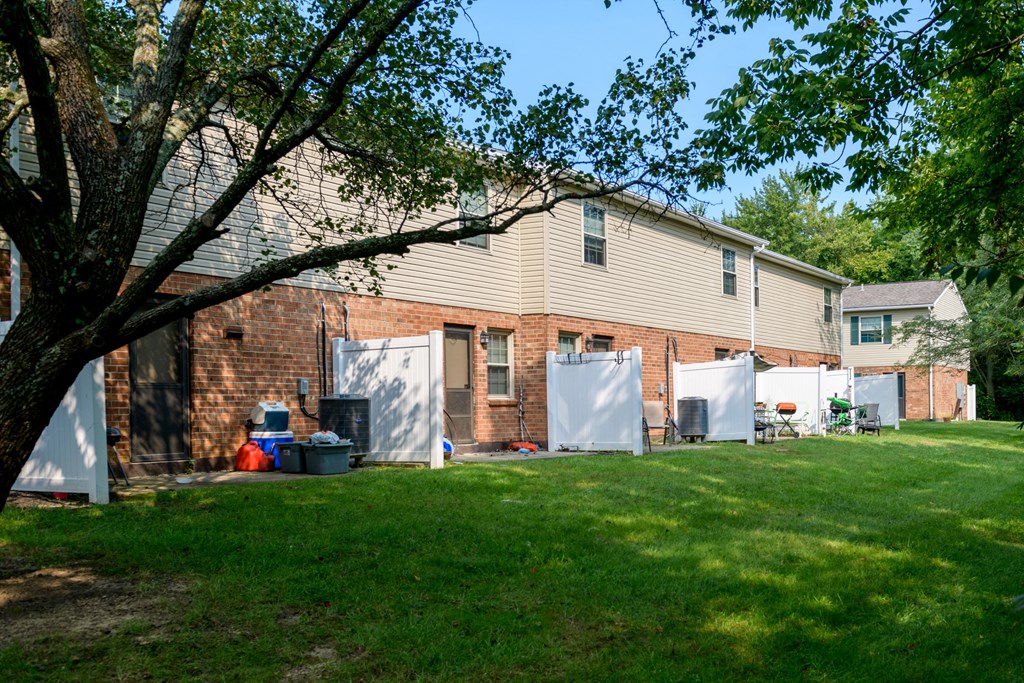 the back of a house with a yard in front of it