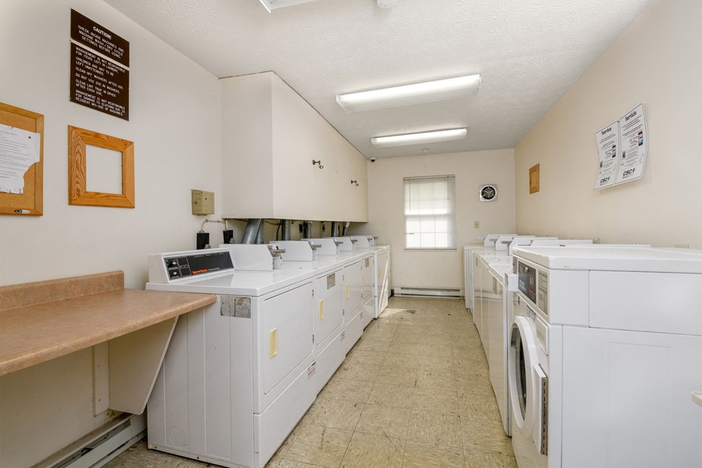 a washer and dryer room in a laundry room with white appliances and counters