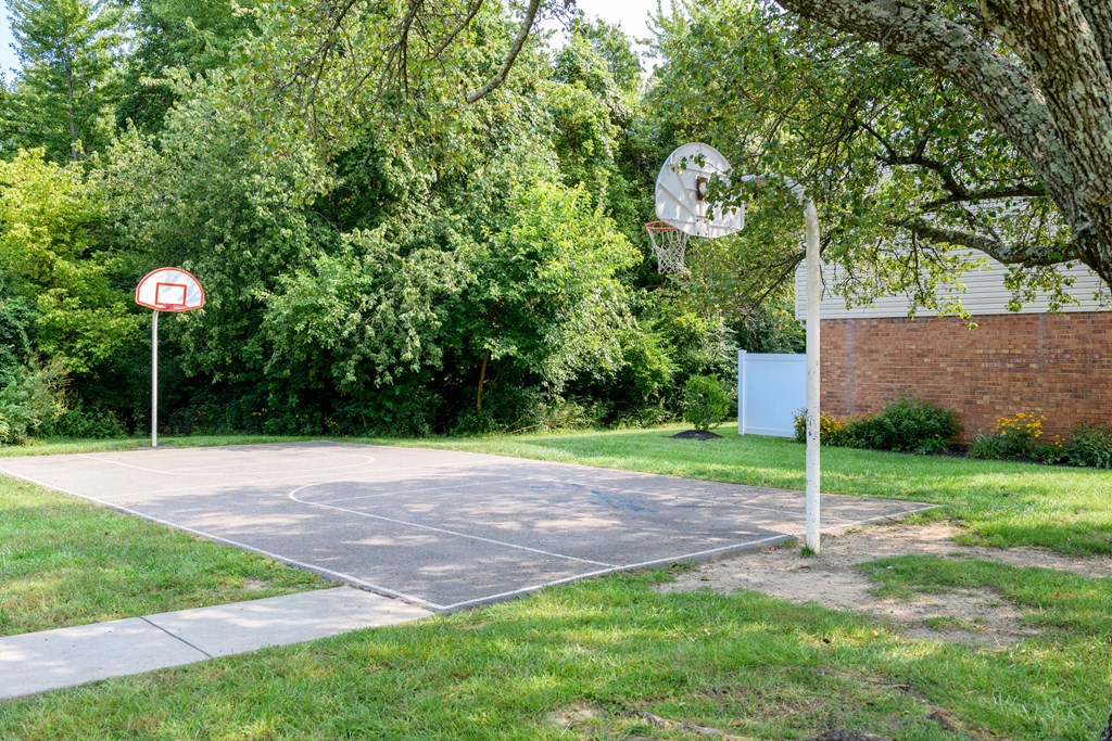 a basketball court in front of a brick building