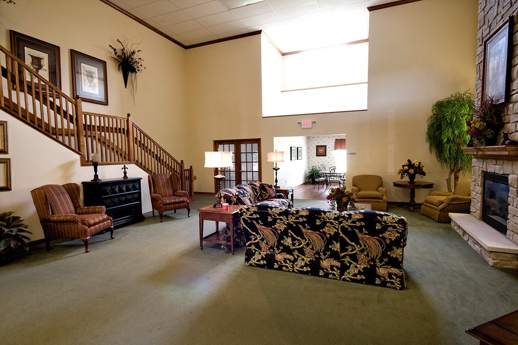 a large living room with a fireplace and a staircase