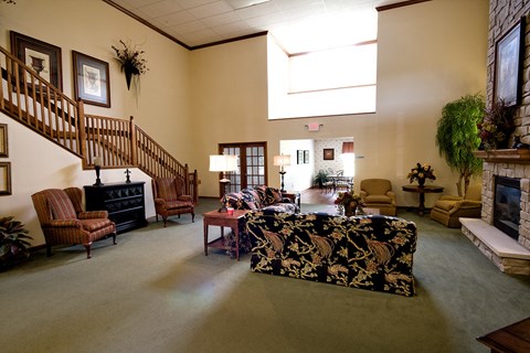 a large living room with a fireplace and a staircase