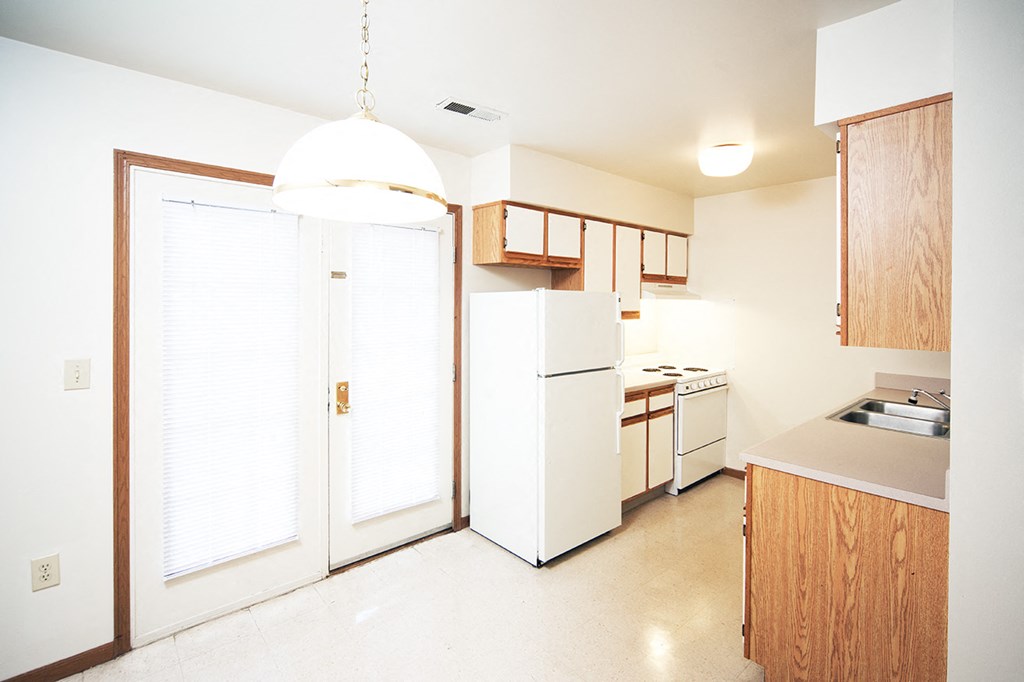 a kitchen with white appliances and a white refrigerator