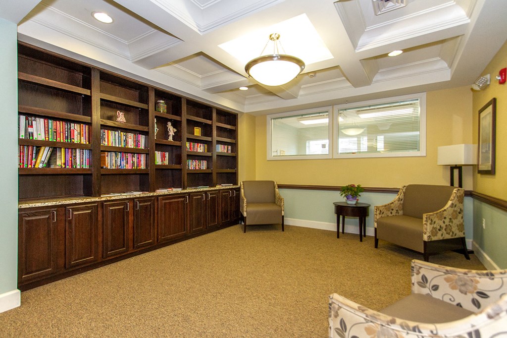 a library with chairs and bookshelves