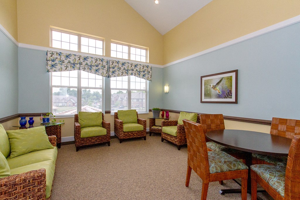 a living room with couches and chairs and a table