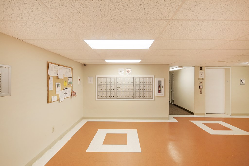 a hall with a calendar on the wall and a door