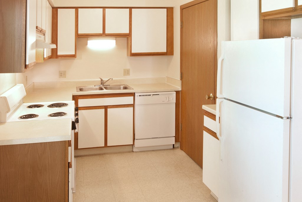 a kitchen with a stove refrigerator and a sink