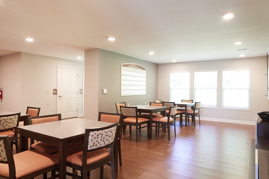 a dining room with tables and chairs and a window