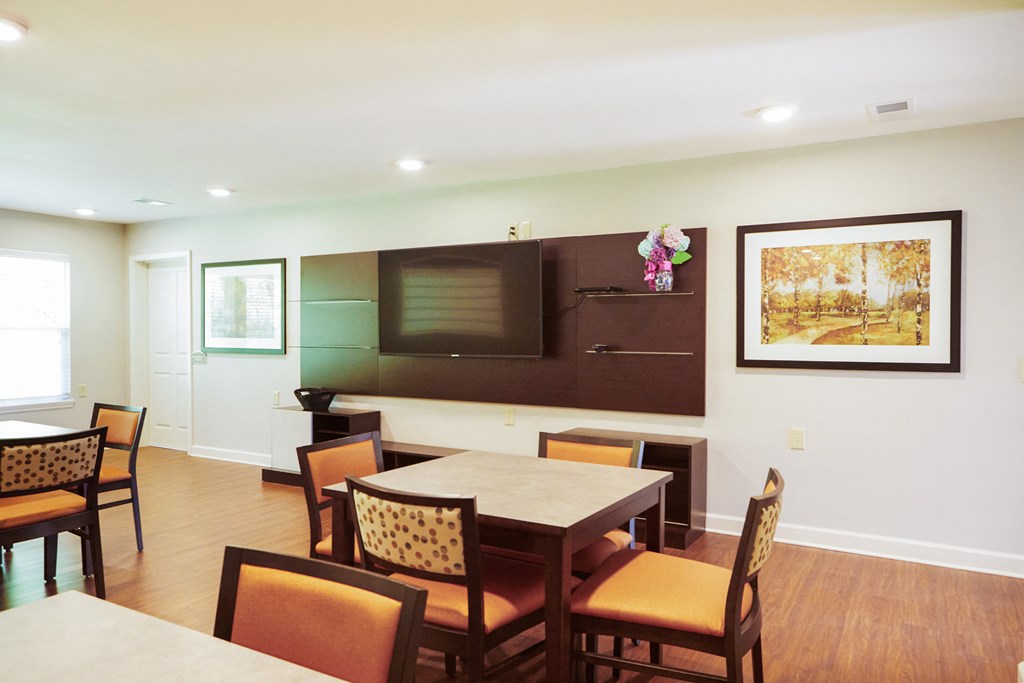 a dining room with a table and chairs and a television