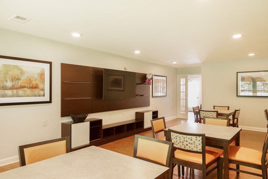 a dining room and living room with a table and chairs