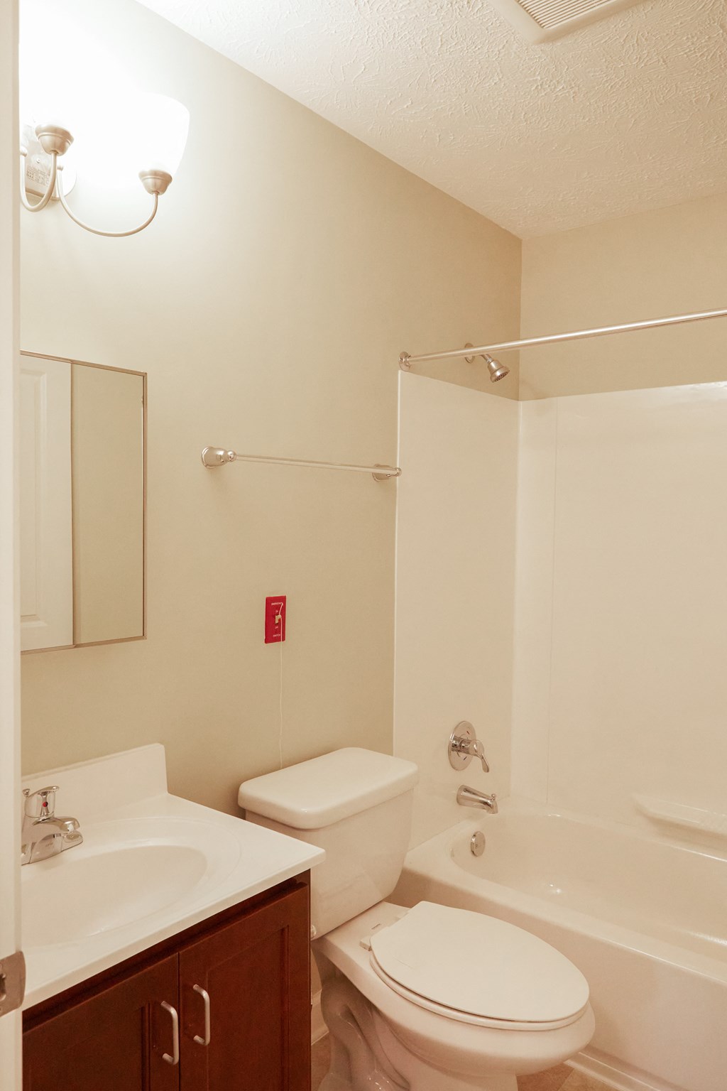 a bathroom with a toilet and a sink and a shower