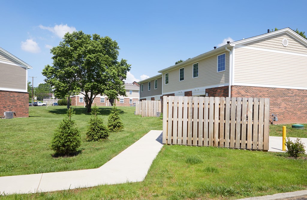 a white picket fence in front of some houses