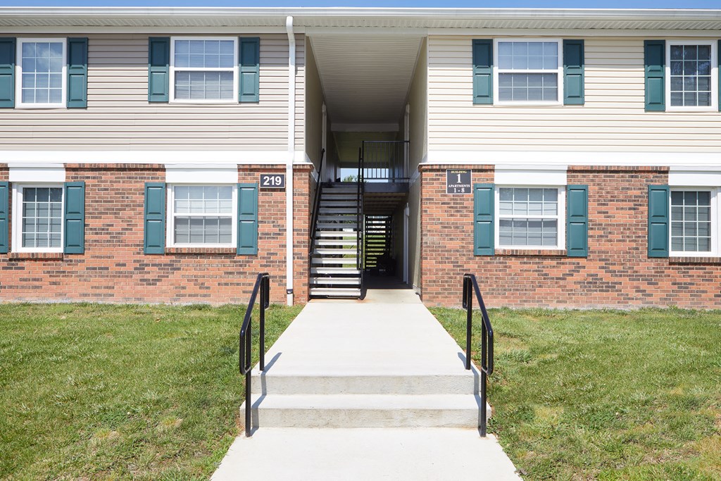 the front of a building with steps and a stairwell