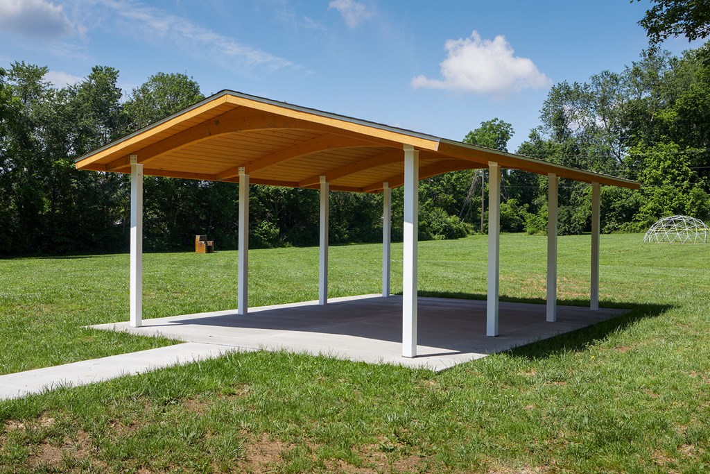 a covered pavilion in a park