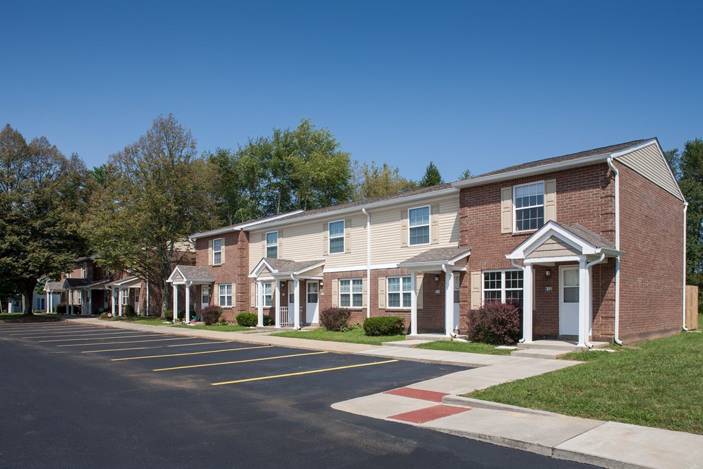 a row of brick apartment buildings on the corner of a street