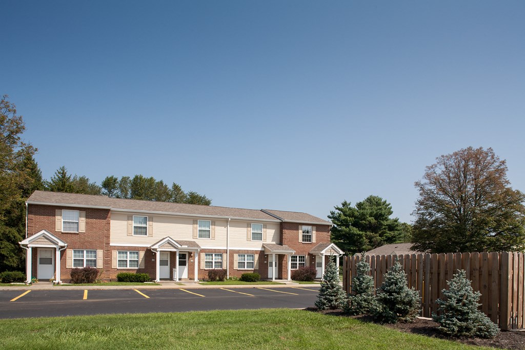 an apartment building with a street in front of it