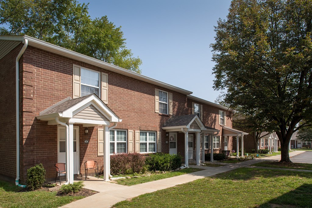 a brick building with a sidewalk in front of it