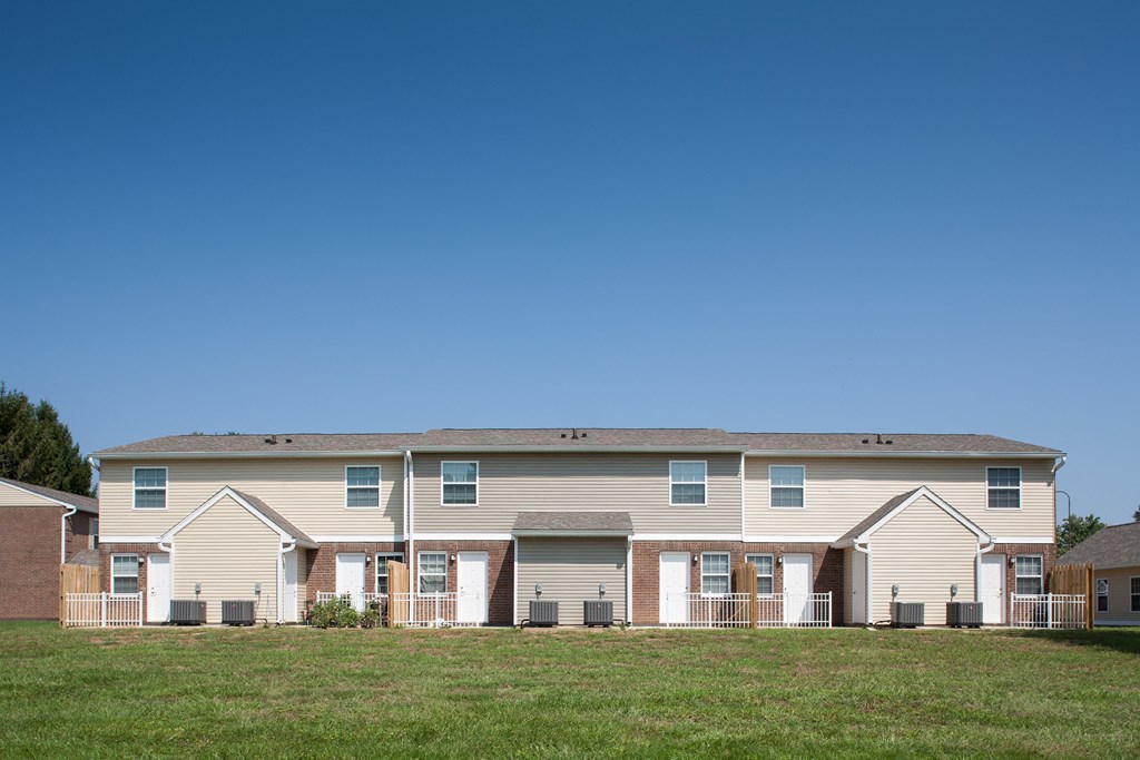 a large house with a yard in front of it